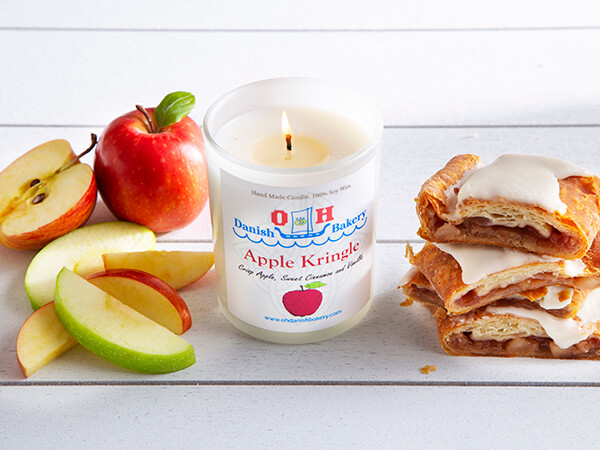 Apple Kringle Candle with a stack of Kringle slices