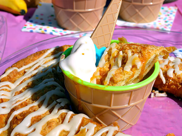 A cup of vanilla ice cream sundae and a Peach Cobbler Kringle 