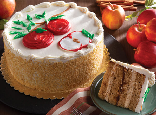 Danish Apple Layer Cake with white frosting and an apple icing design
