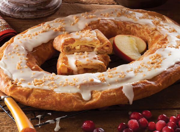 Harvest Kringle surrounded by cranberries and apple slices