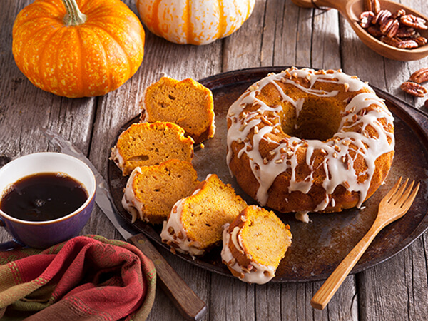 Pumpkin Crown Cake on a ceramic plate with a cup of coffee