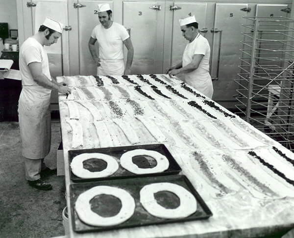 Ray Olesen making Kringles with other bakers