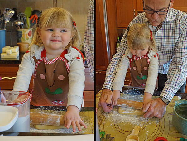 Young girl rolls dough with grandparent