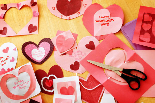 Table with homemade heart-shaped Valentine cards