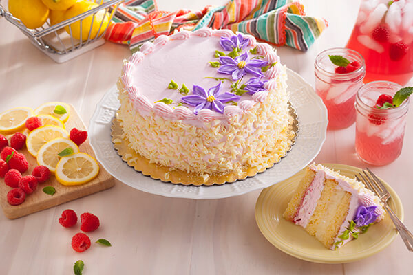 Raspberry Lemonade Mousse Cake with two glasses of pink lemonade