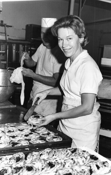 A photograph of Myrna Olesen and Ray Olesen making baked goods