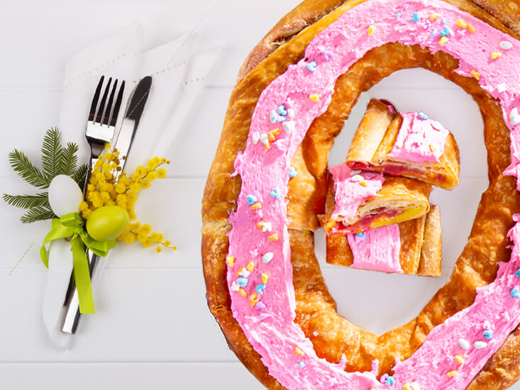 A Raspberry Lemon Cheese Cake Kringle set out on a table