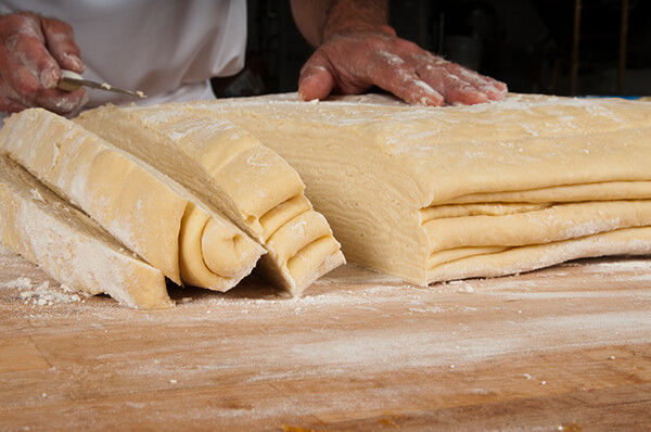 Kringle dough being cut