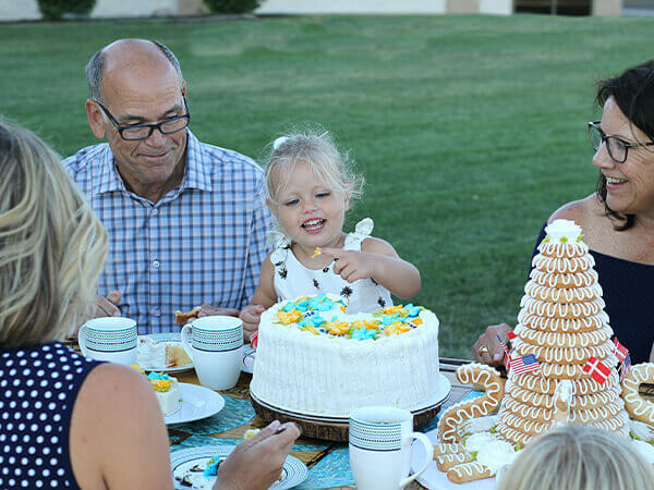 3rd generation owner, Eric Olesen, with one of his grandchildren enjoying an O&H Danish Bakery dessert spread