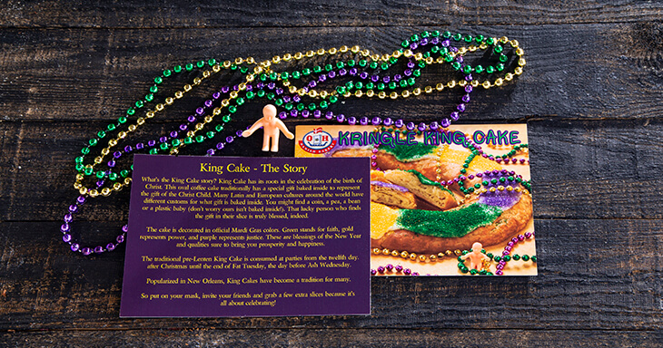 This package also includes a plastic baby, 3 strands of Mardi Gras Beads and the King Cake Story.
